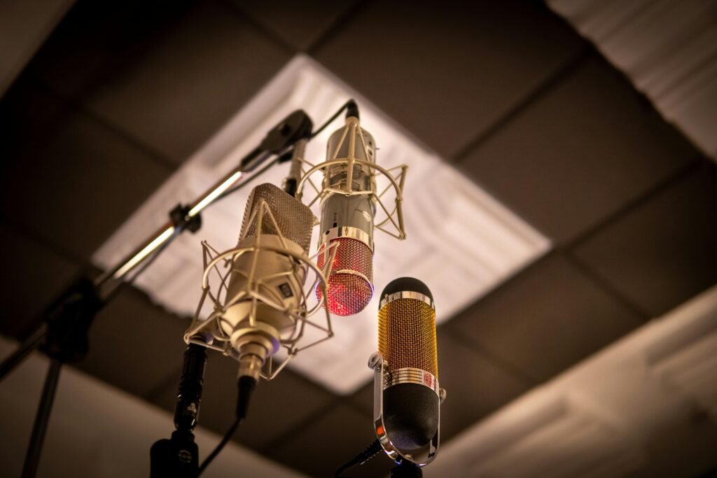 Three condenser microphones arranged for optimal sound capture in a recording studio.